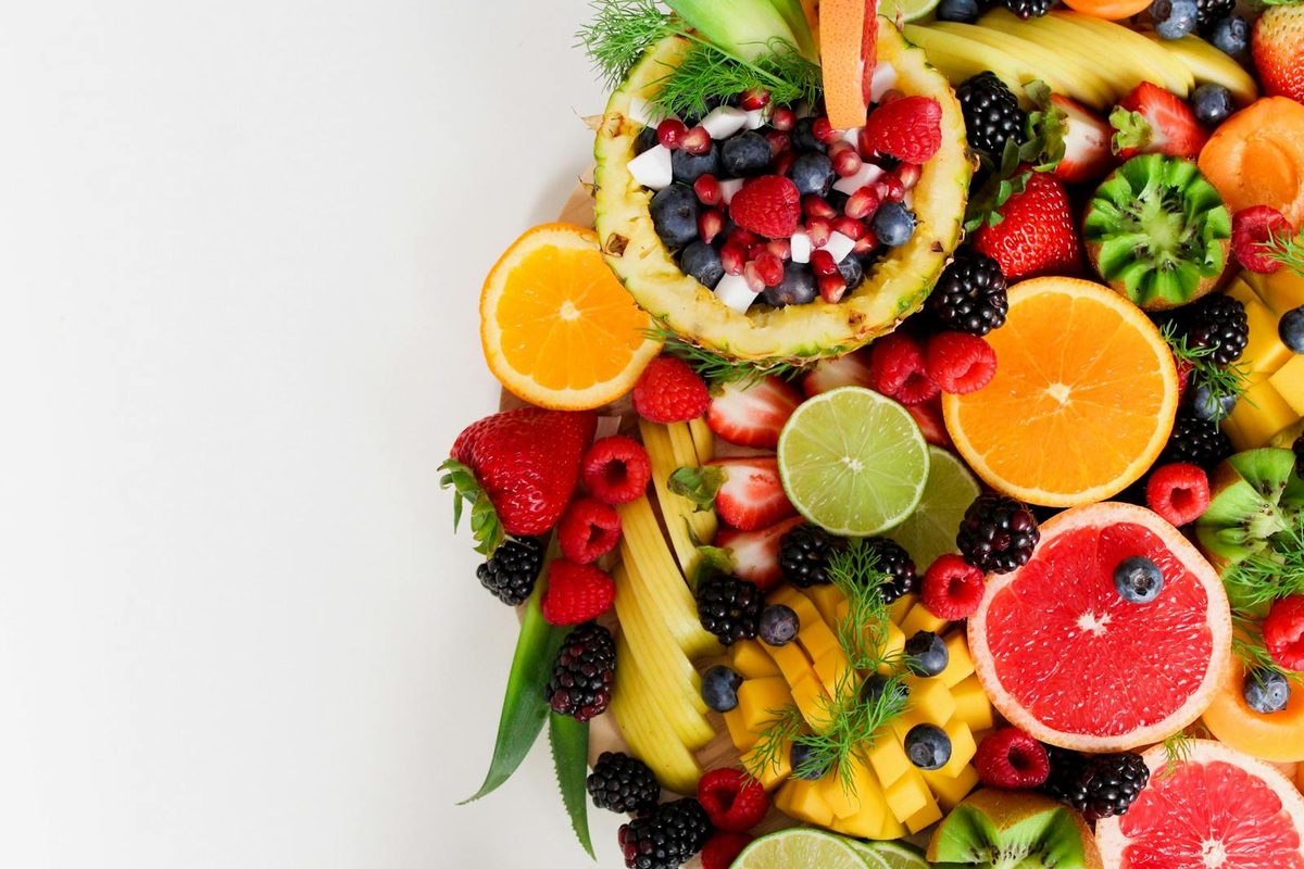 Cross adorned with traditional Salvadoran fruits — mangos, jocotes, pineapples and cashew apples — for the May 3rd celebration